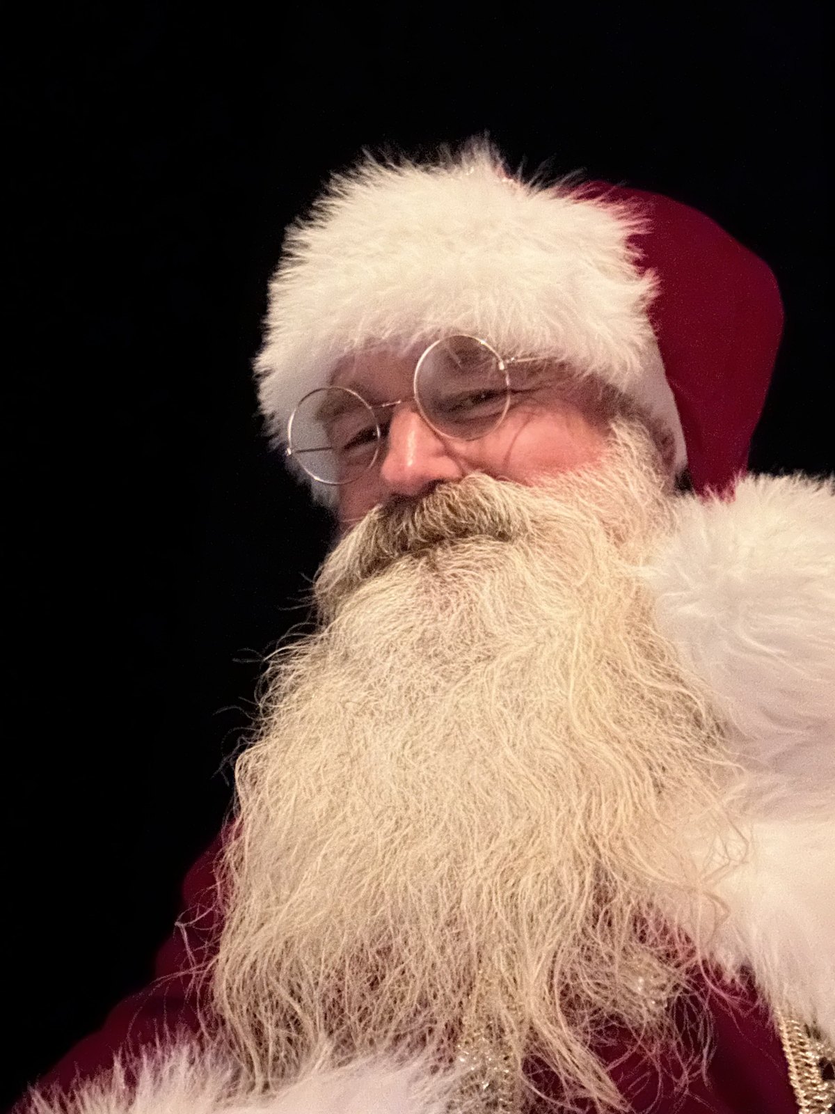 Cinematic low-light portrait of Santa in profile against a dark background